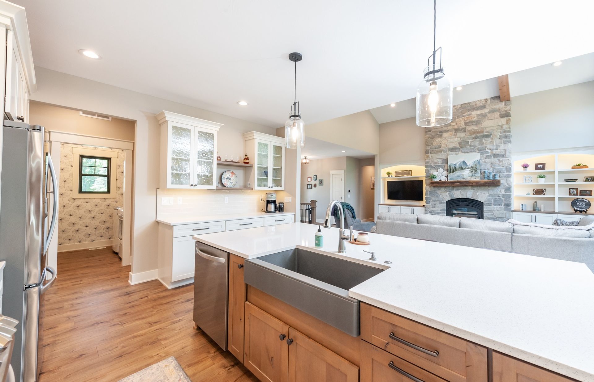 A kitchen with wooden cabinets , stainless steel appliances , and a large sink.