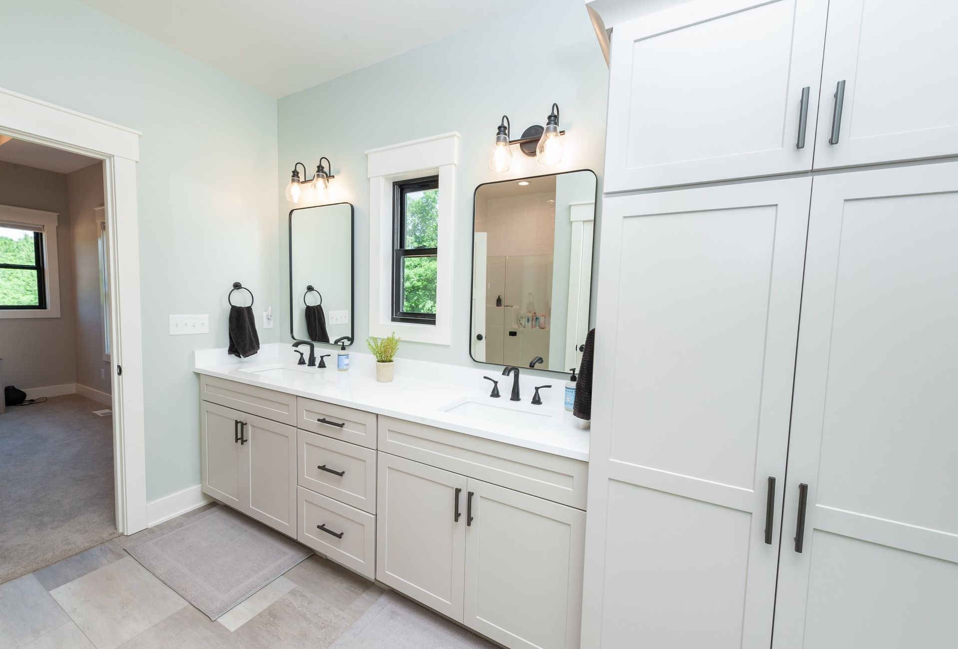 A bathroom with two sinks and two mirrors.