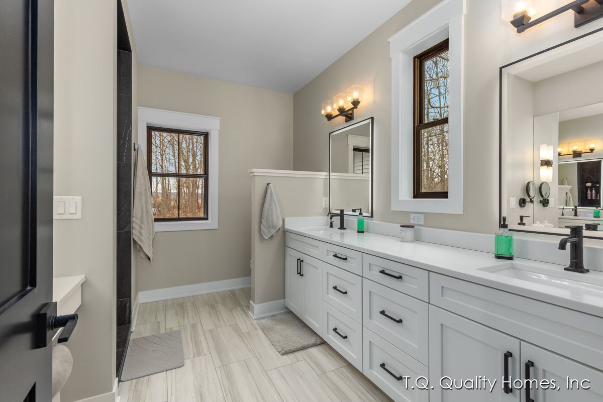 A bathroom with two sinks and two mirrors