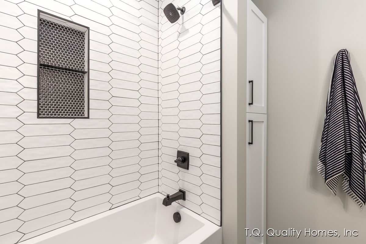 A bathroom with a bathtub and a shower.