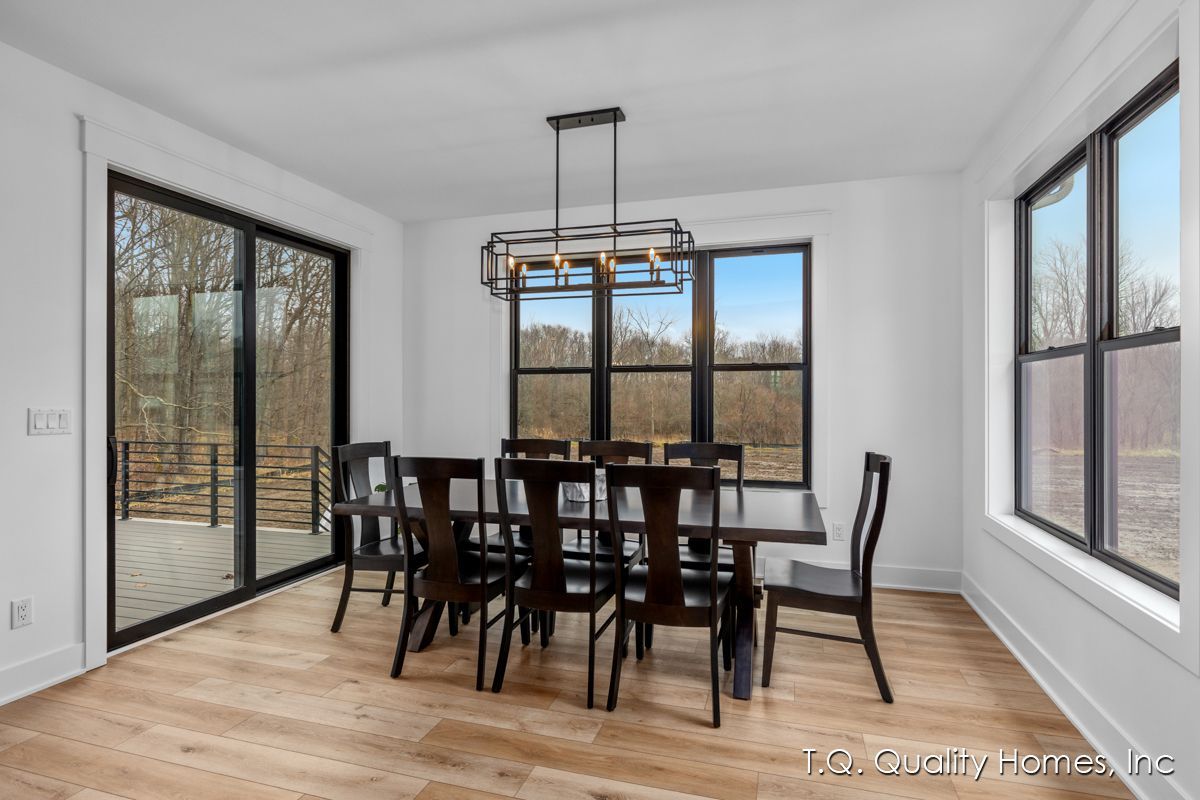 A dining room with a table and chairs and a chandelier