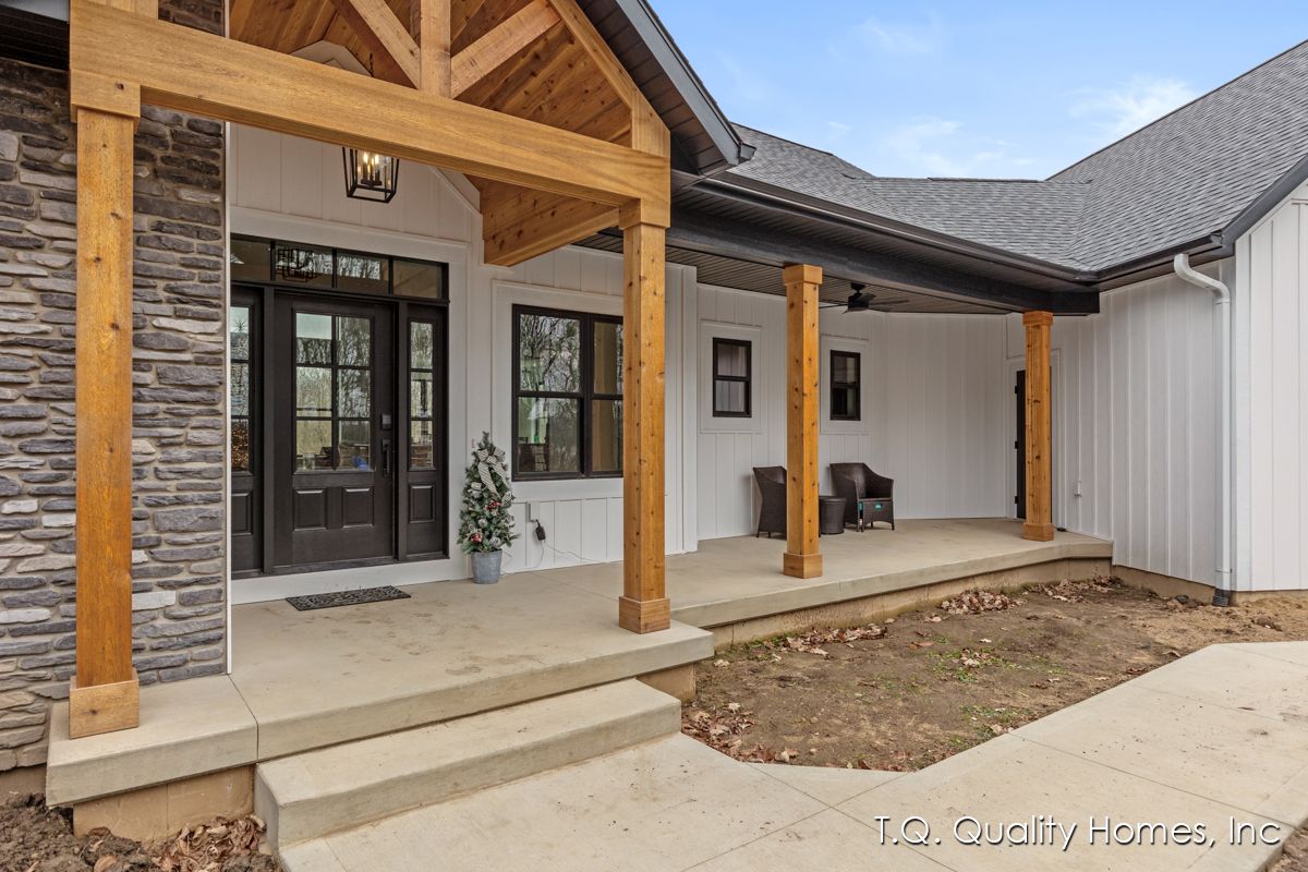 The front porch of a house with a wooden roof