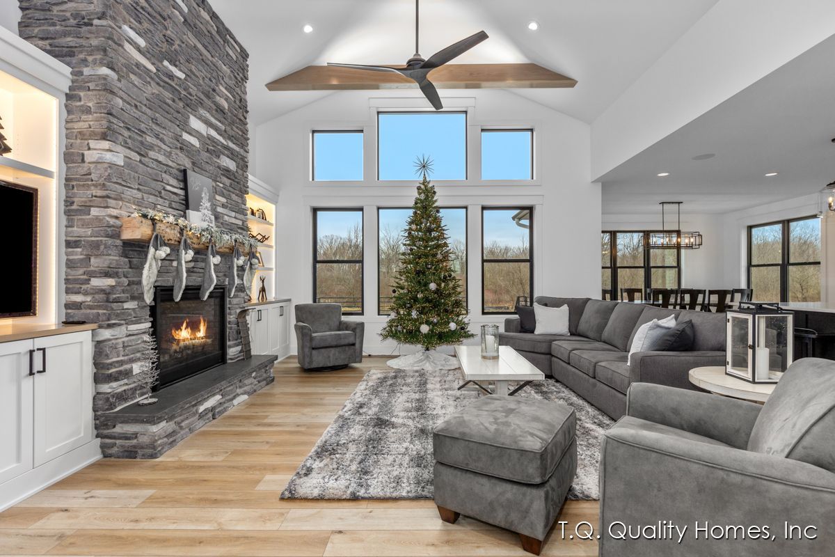A living room with a fireplace and a christmas tree