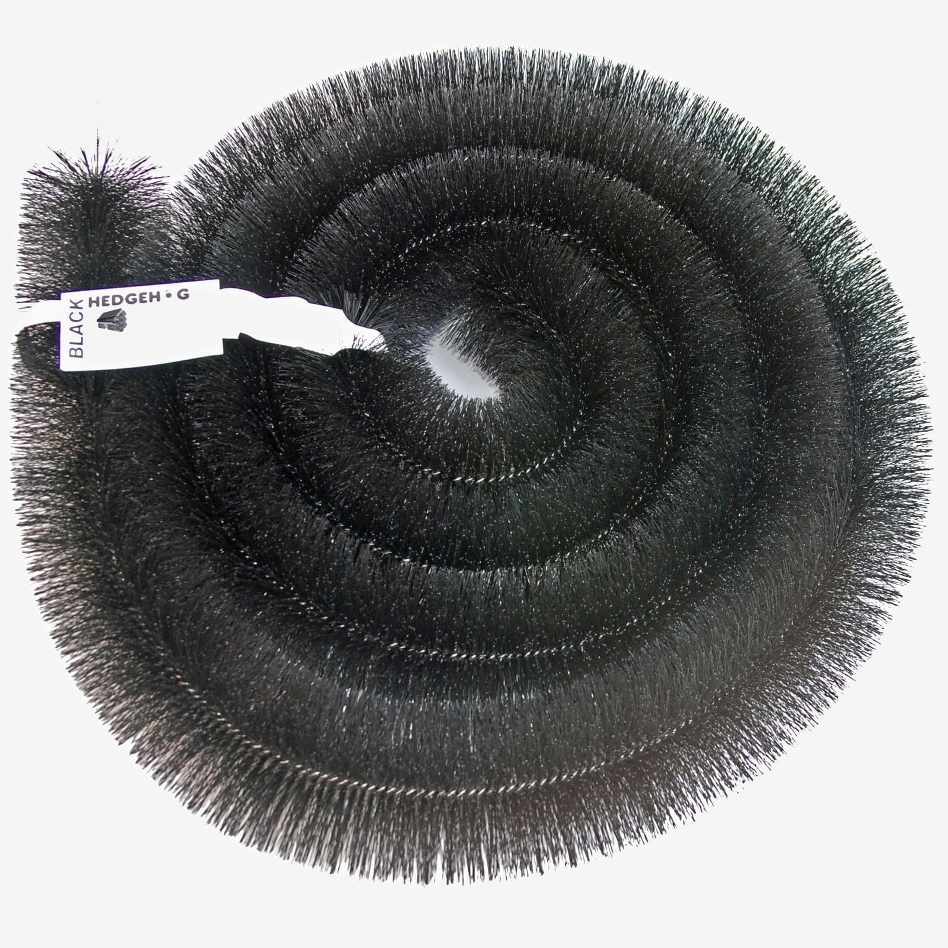 A bristle brush gutter guard, rolled up in a spiral. Product image, with a white background. Used to protect UK homes from rain damage.