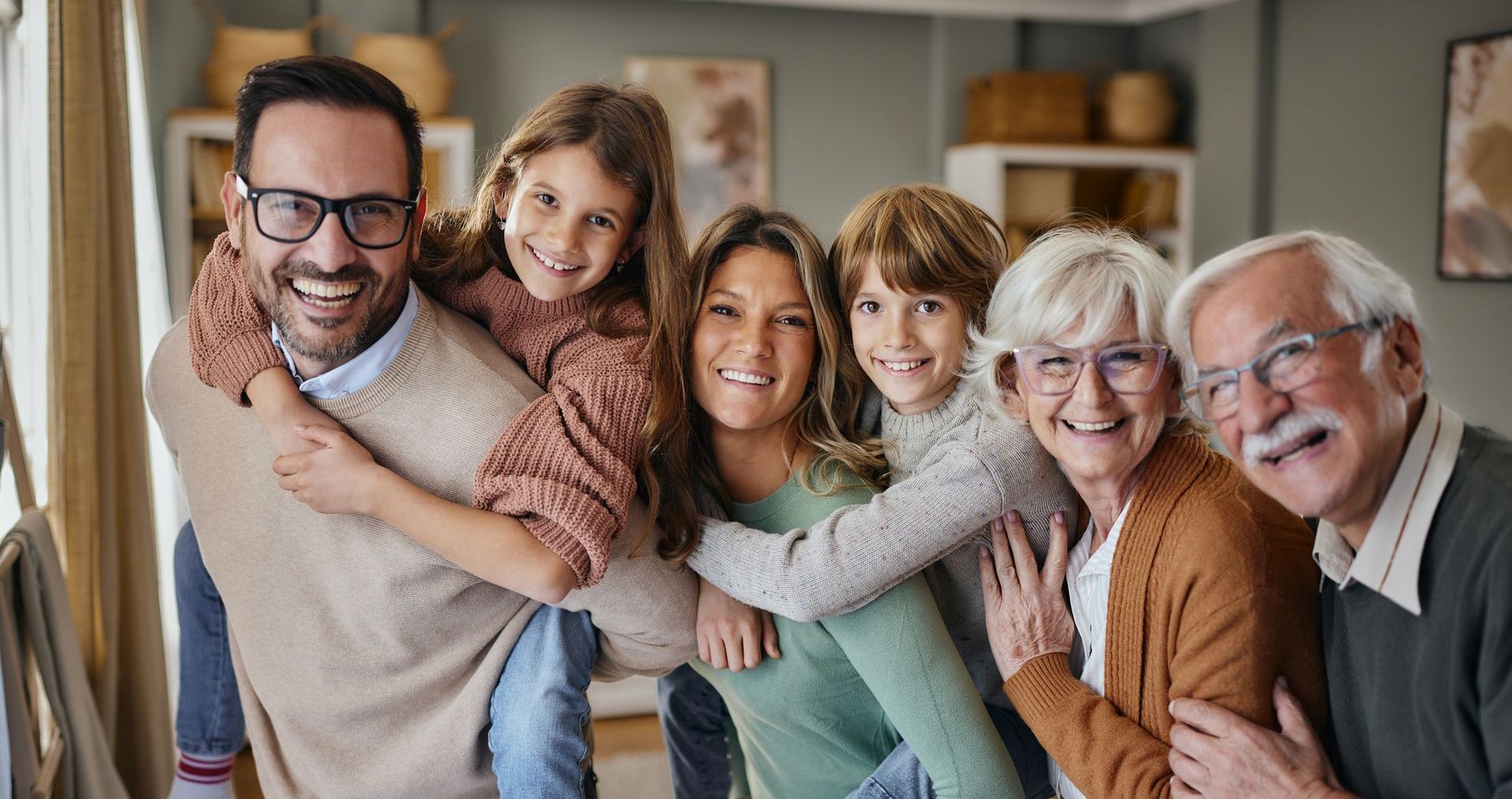 A family is posing for a picture together in a living room.
