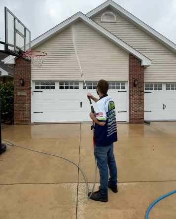 Green Pro Services employee soft washing house in Manteno Illinois