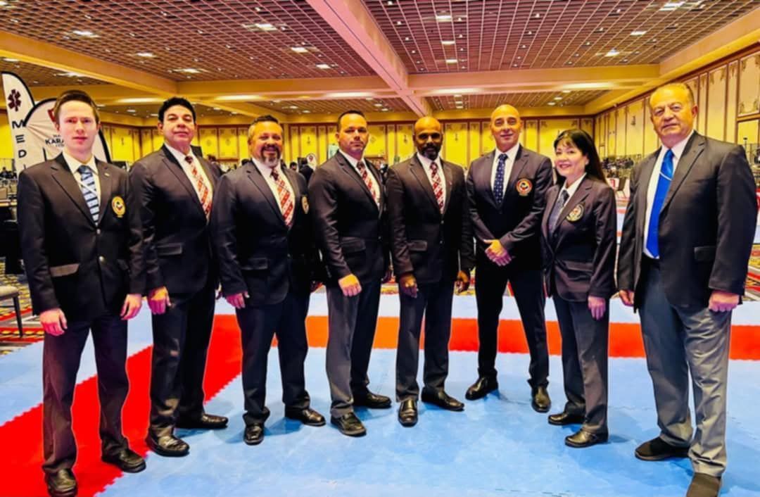 A group of men in suits and ties are posing for a picture.