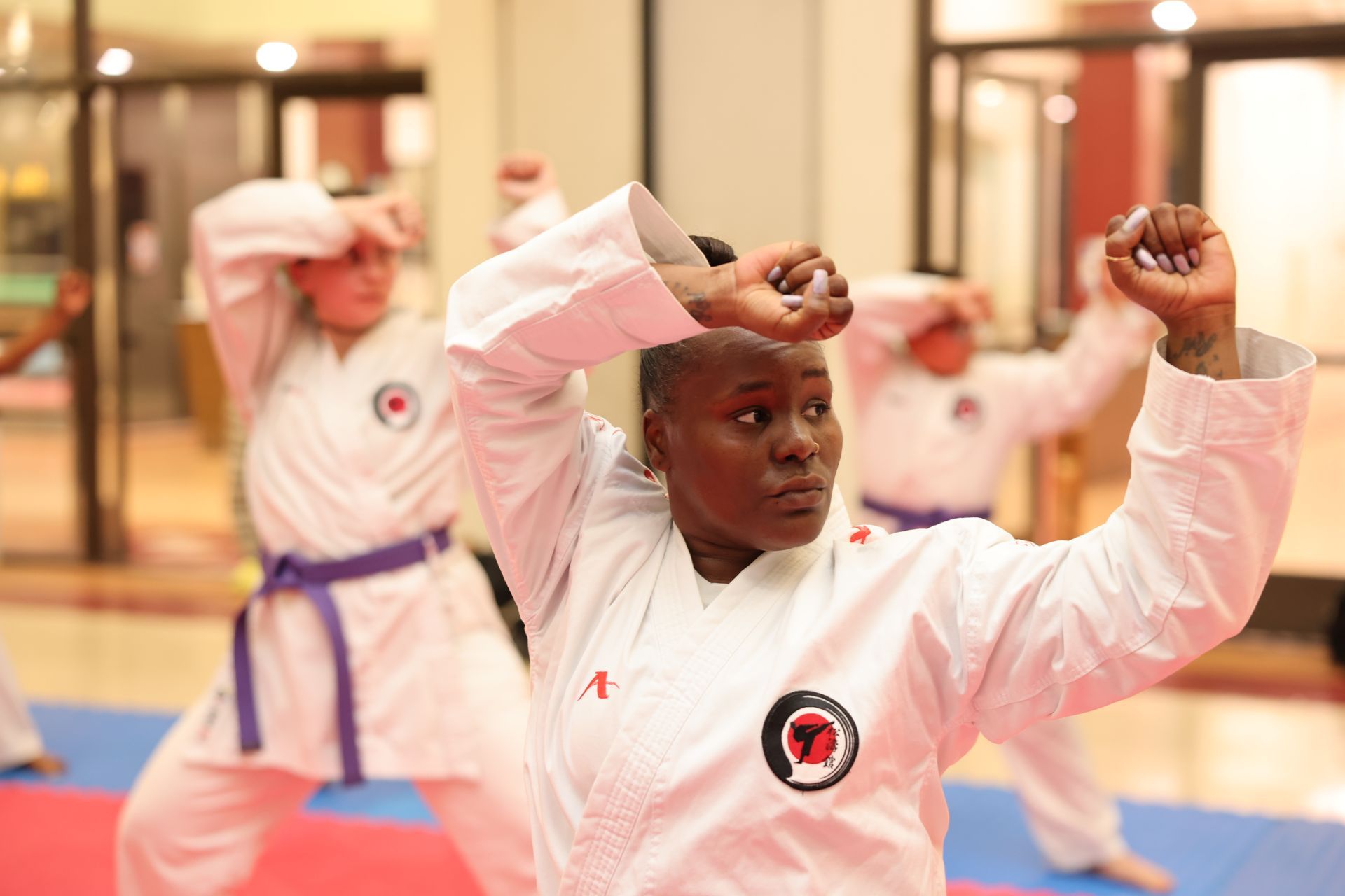 A man is balancing on two medicine balls and another man