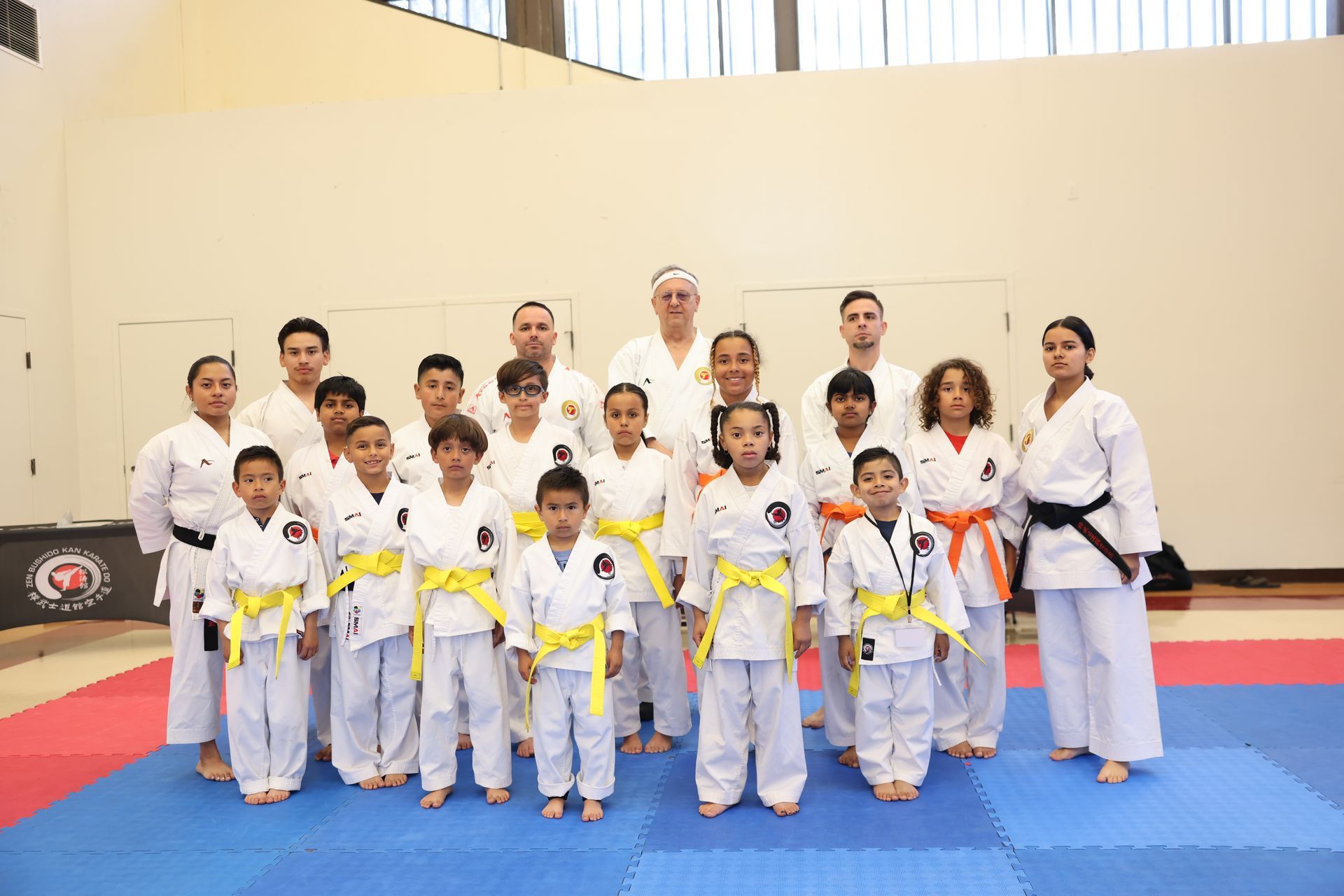 A group of people in karate uniforms are posing for a picture.