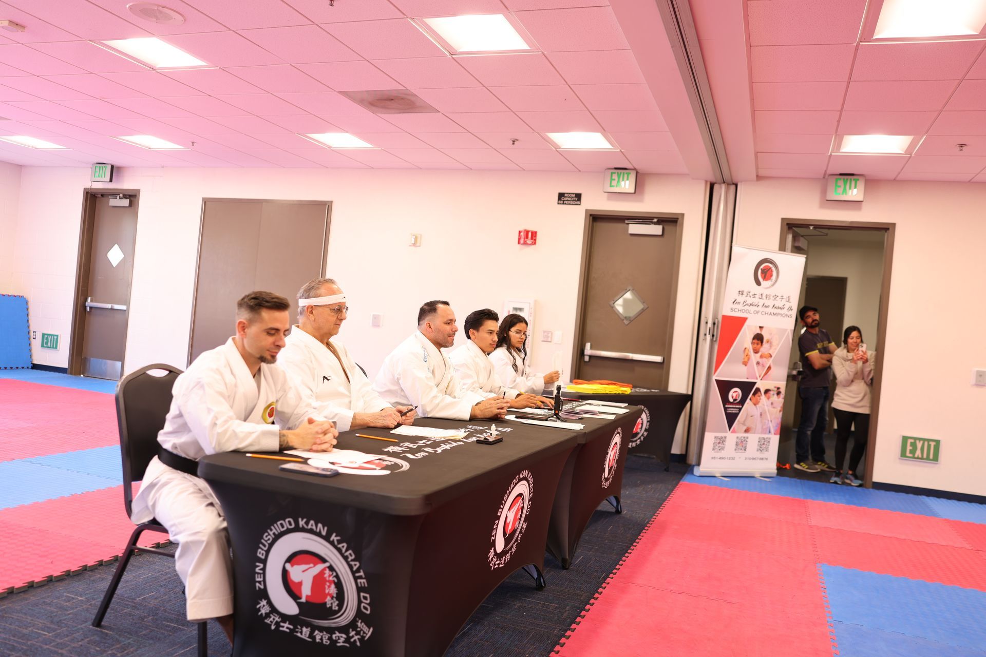A group of people are sitting at tables in a room.