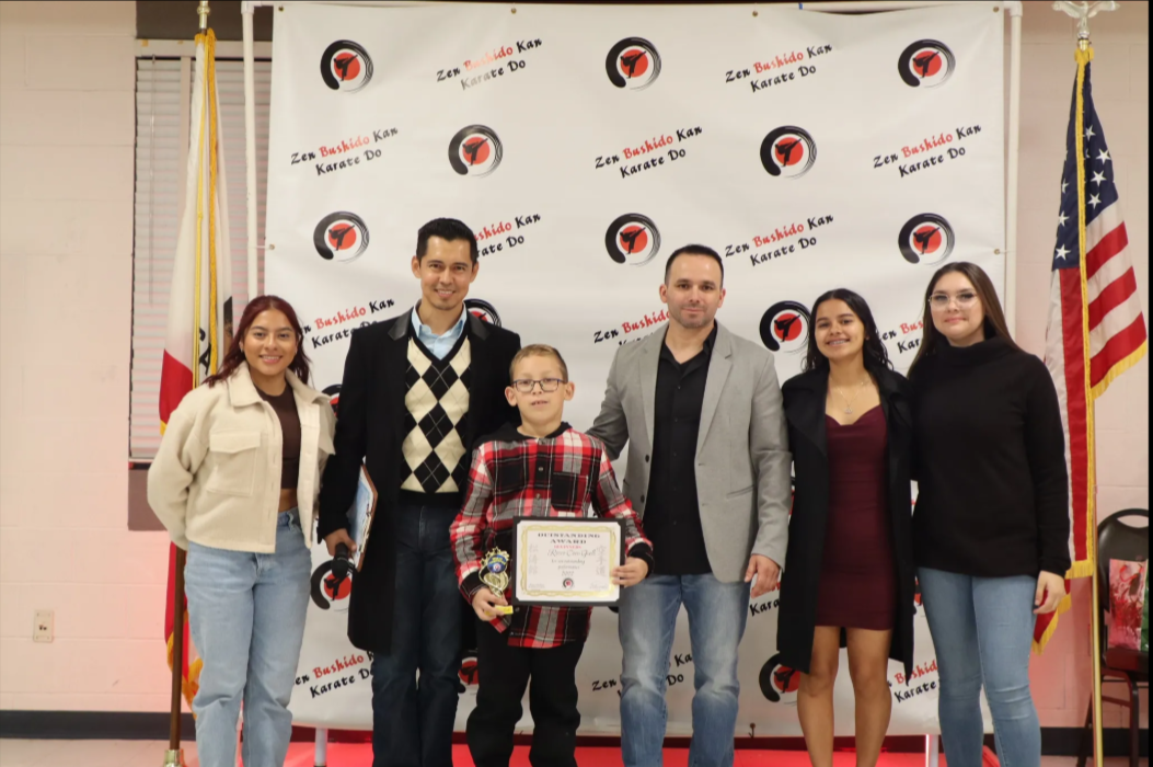 A group of people standing next to each other holding a certificate.