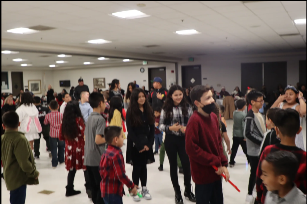A large group of people are dancing in a room.