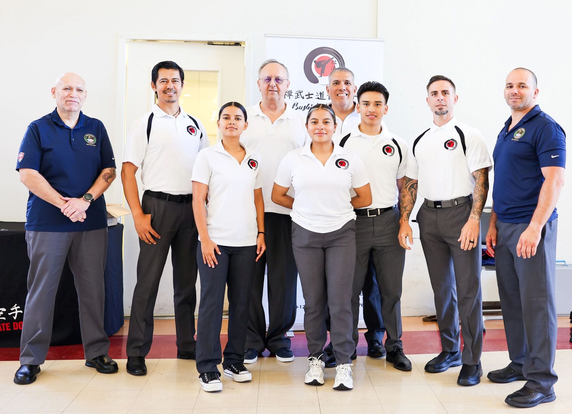 A group of people are posing for a picture in a room.