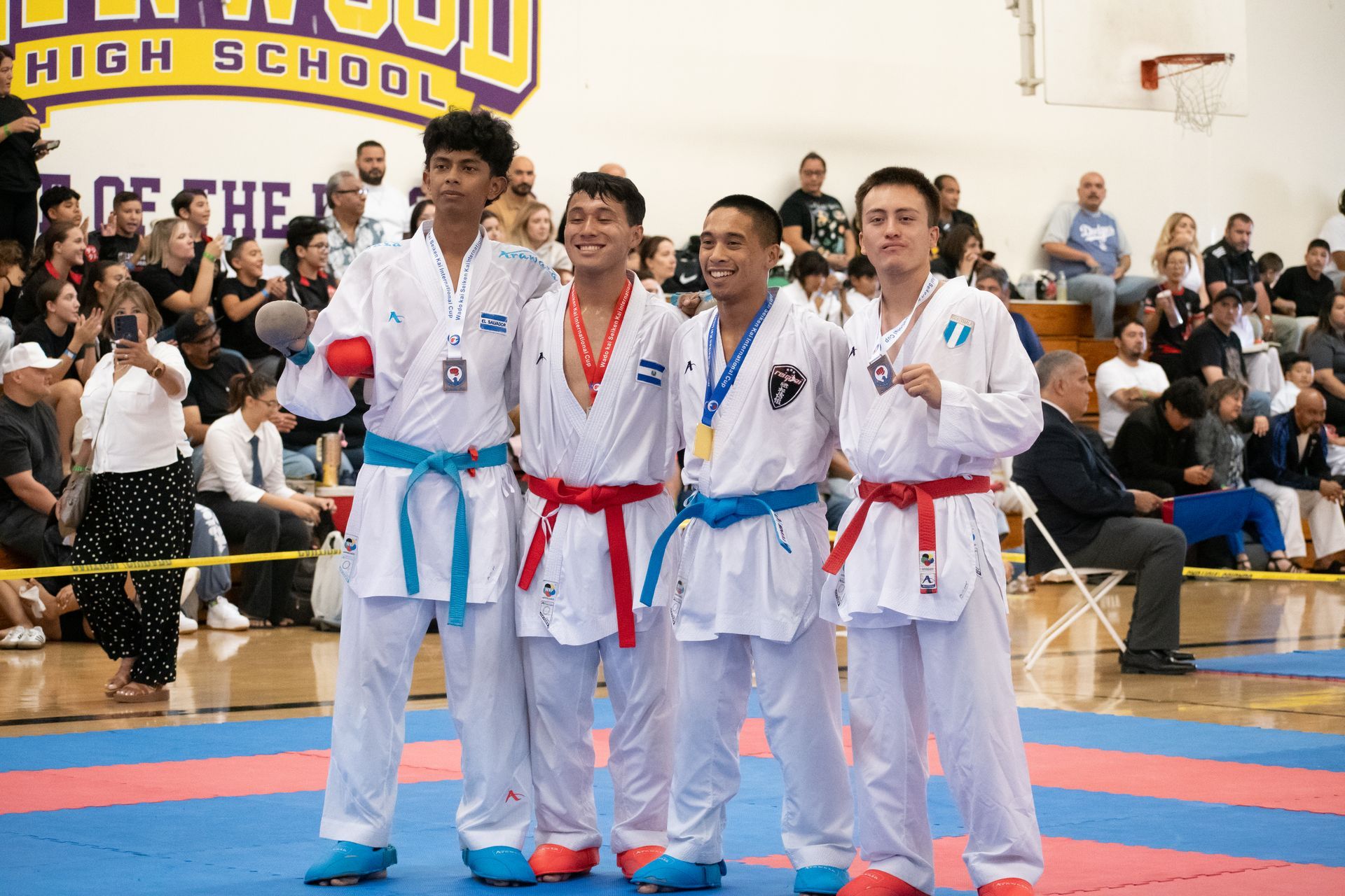 A group of young men in karate uniforms are posing for a picture.