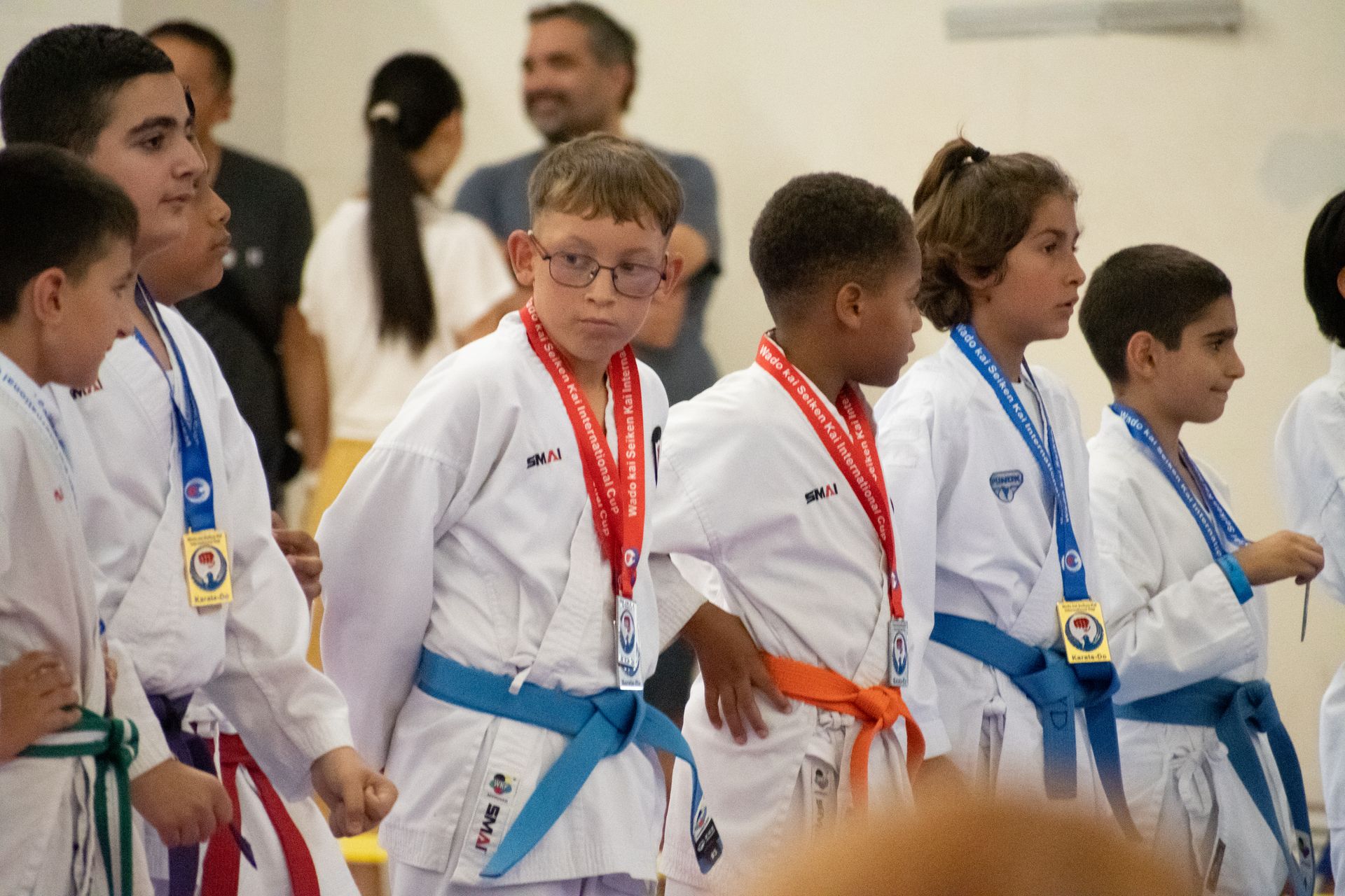 A group of young boys in karate uniforms with medals around their necks