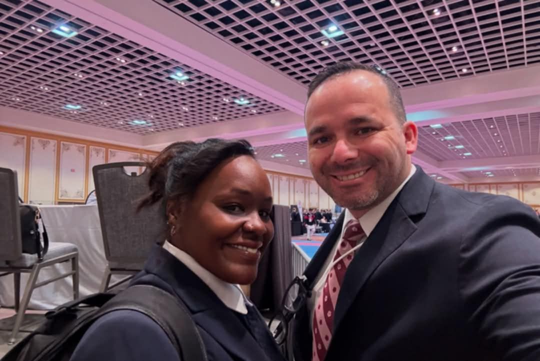A man and a woman are posing for a picture in a room.