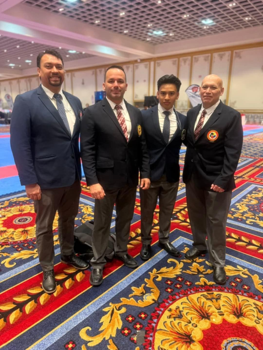 A group of men in suits and ties are posing for a picture