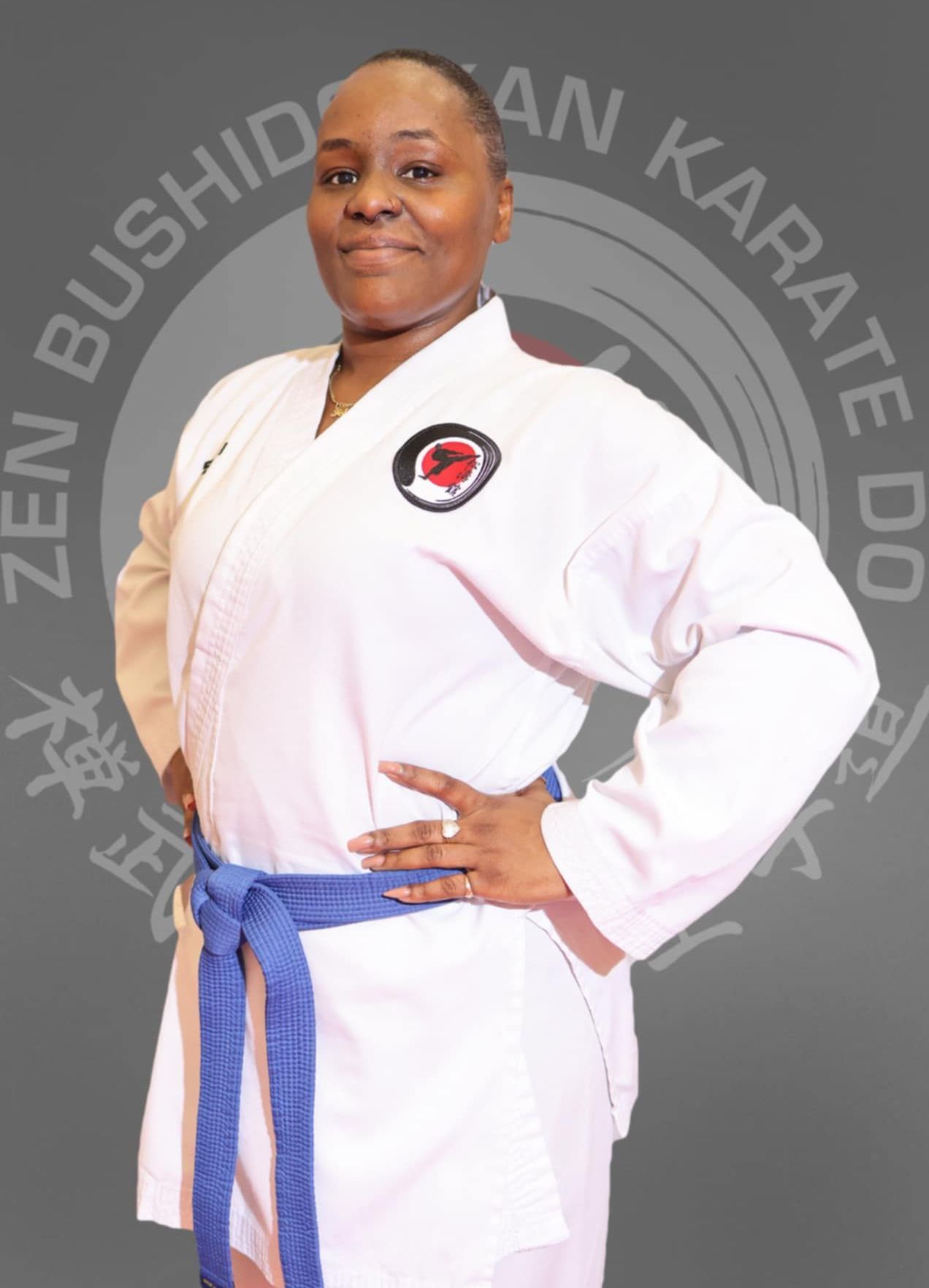 A woman in a white karate uniform with a blue belt