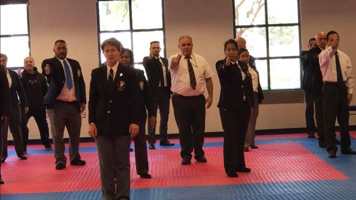 A group of people in suits and ties are standing in a room.
