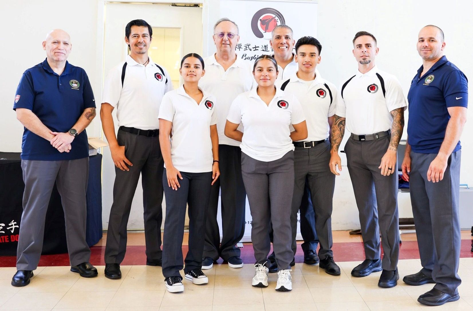 A group of people are posing for a picture in a room.