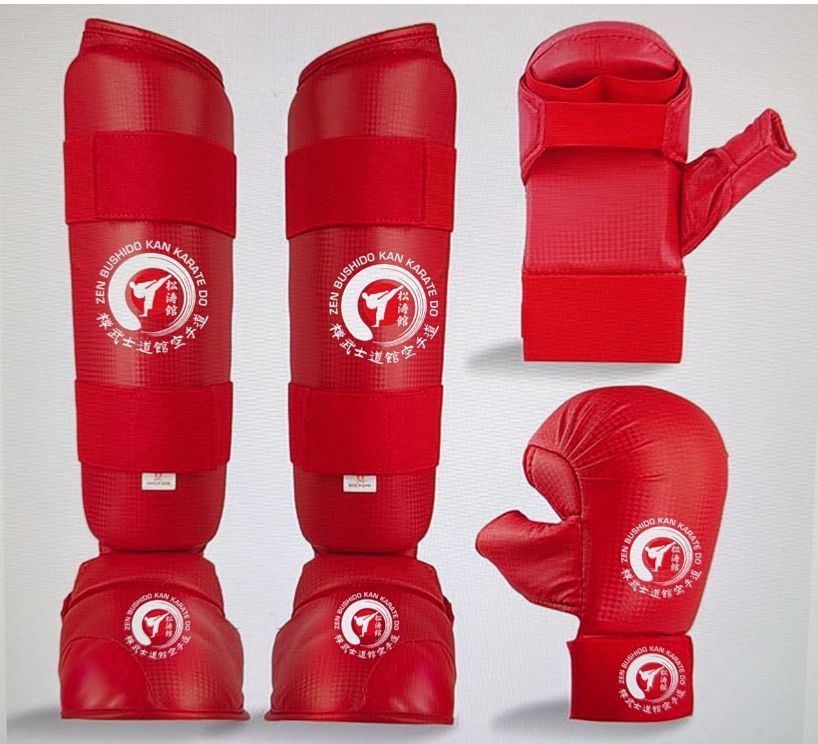 A set of red karate gloves and shin guards