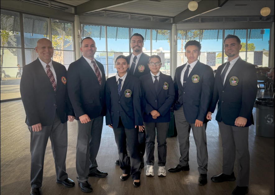 A group of people in suits and ties are posing for a picture.
