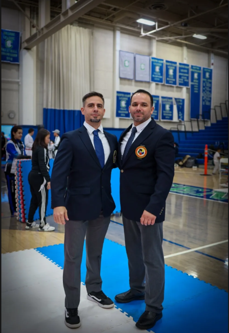 Two men standing next to each other in a gym