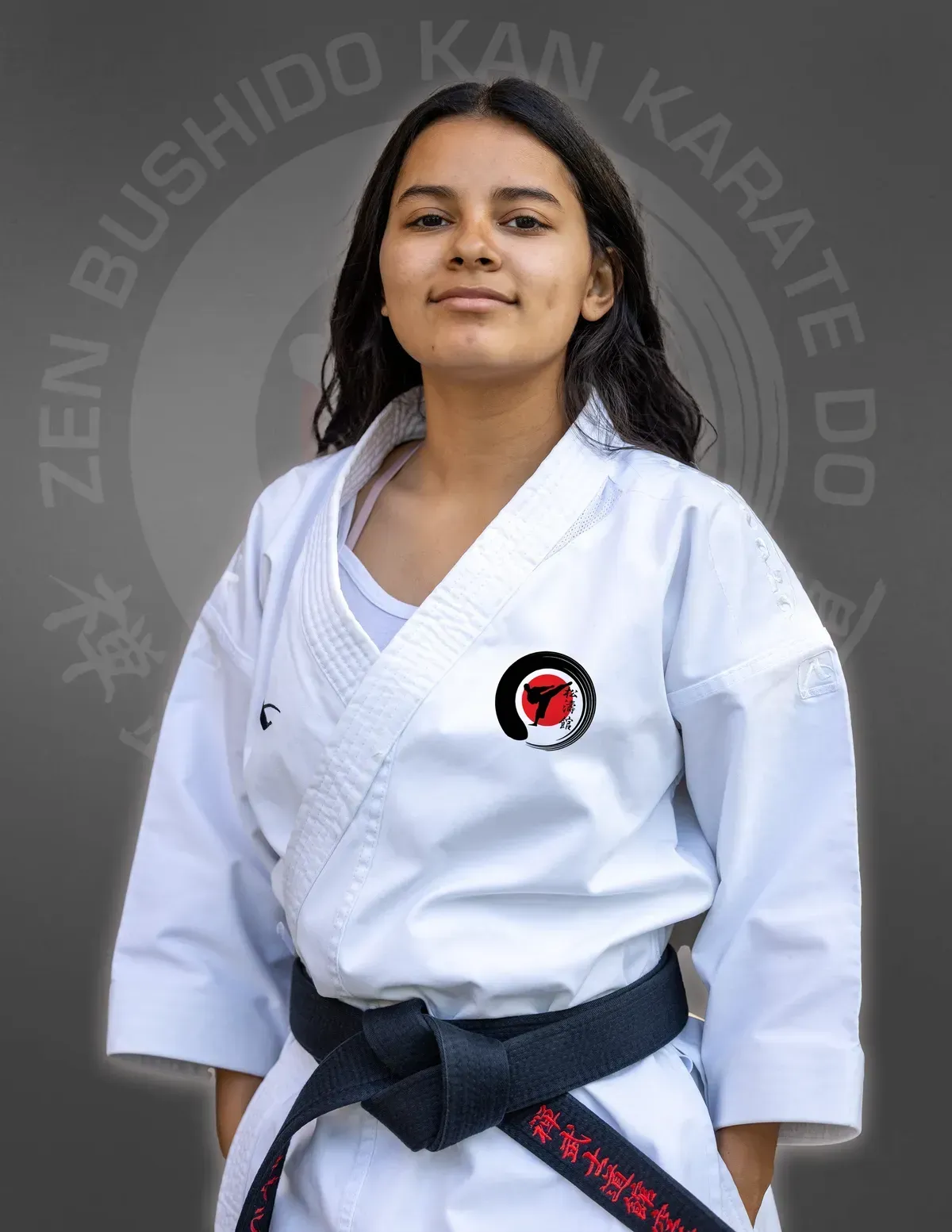A girl in a white karate uniform with a black belt