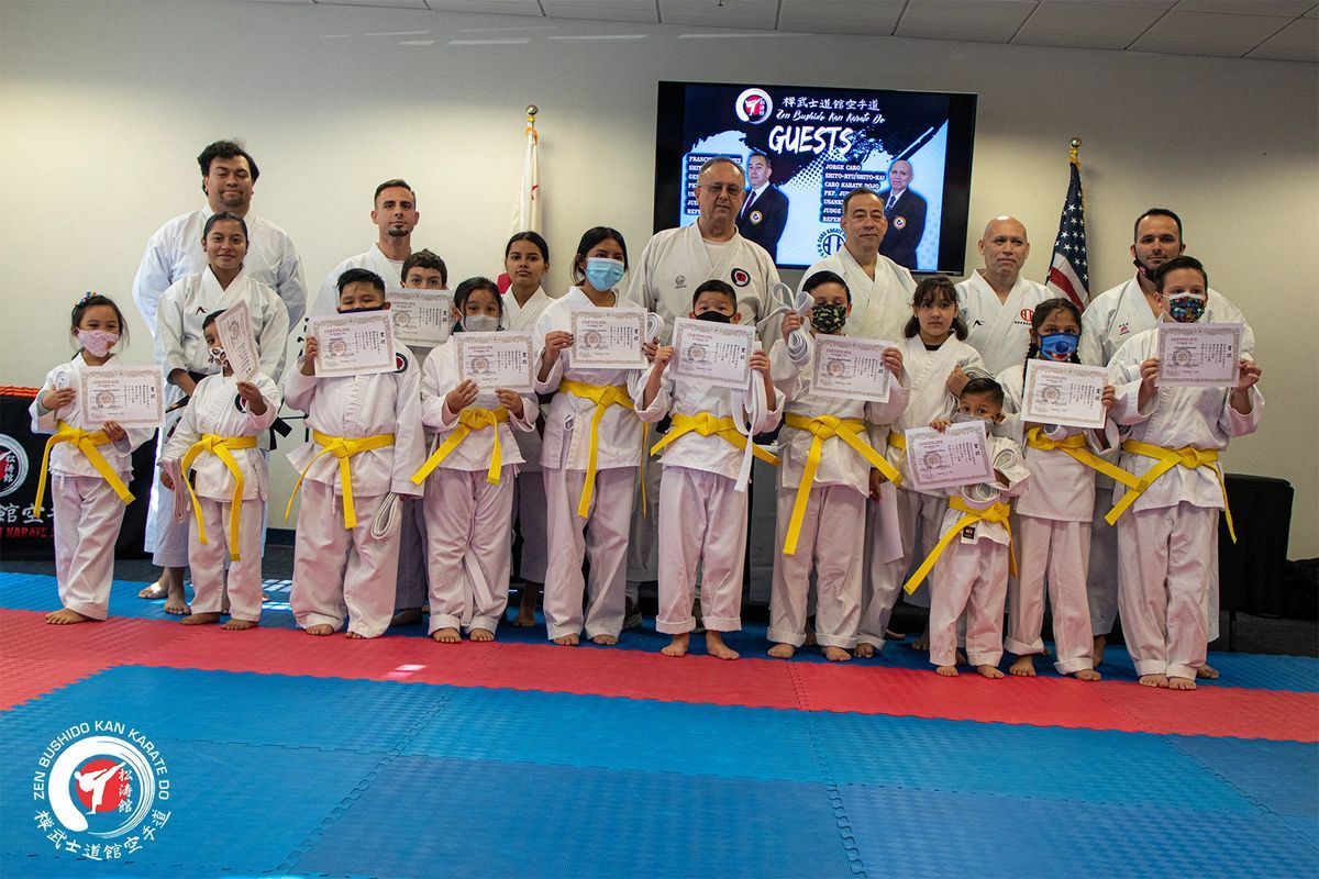 A group of people in karate uniforms are posing for a picture.