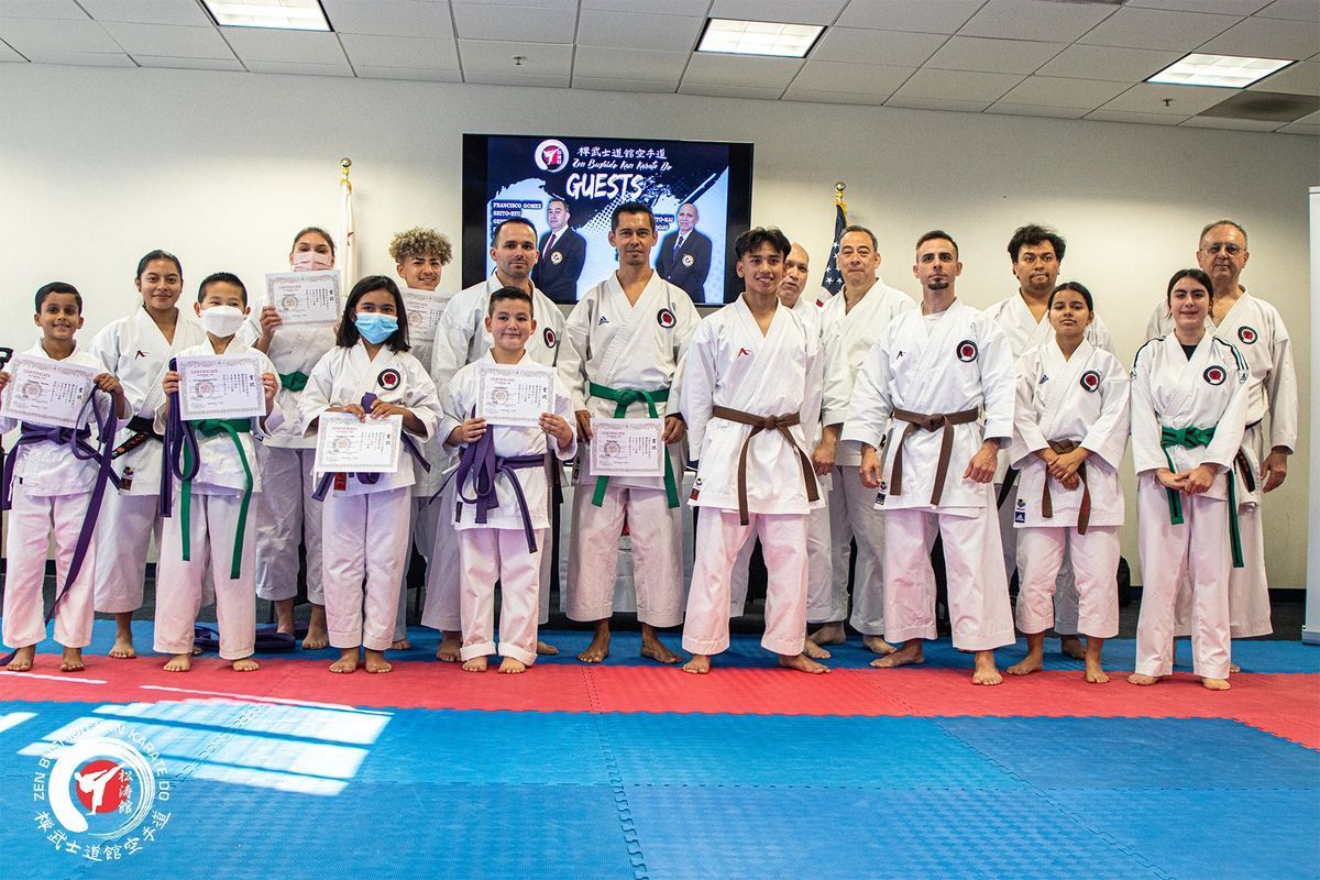 A group of people in karate uniforms are posing for a picture.