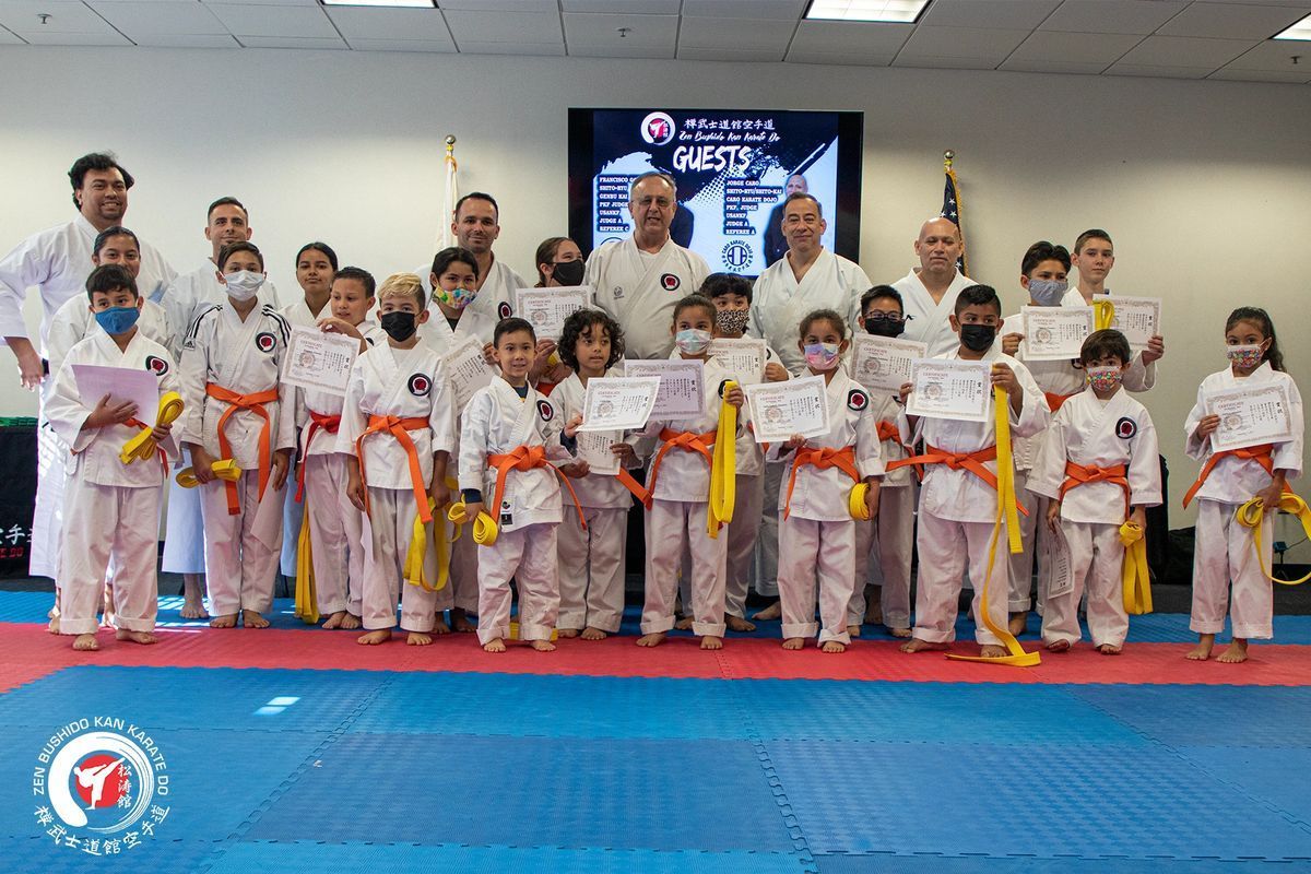 A group of people in karate uniforms are posing for a picture.