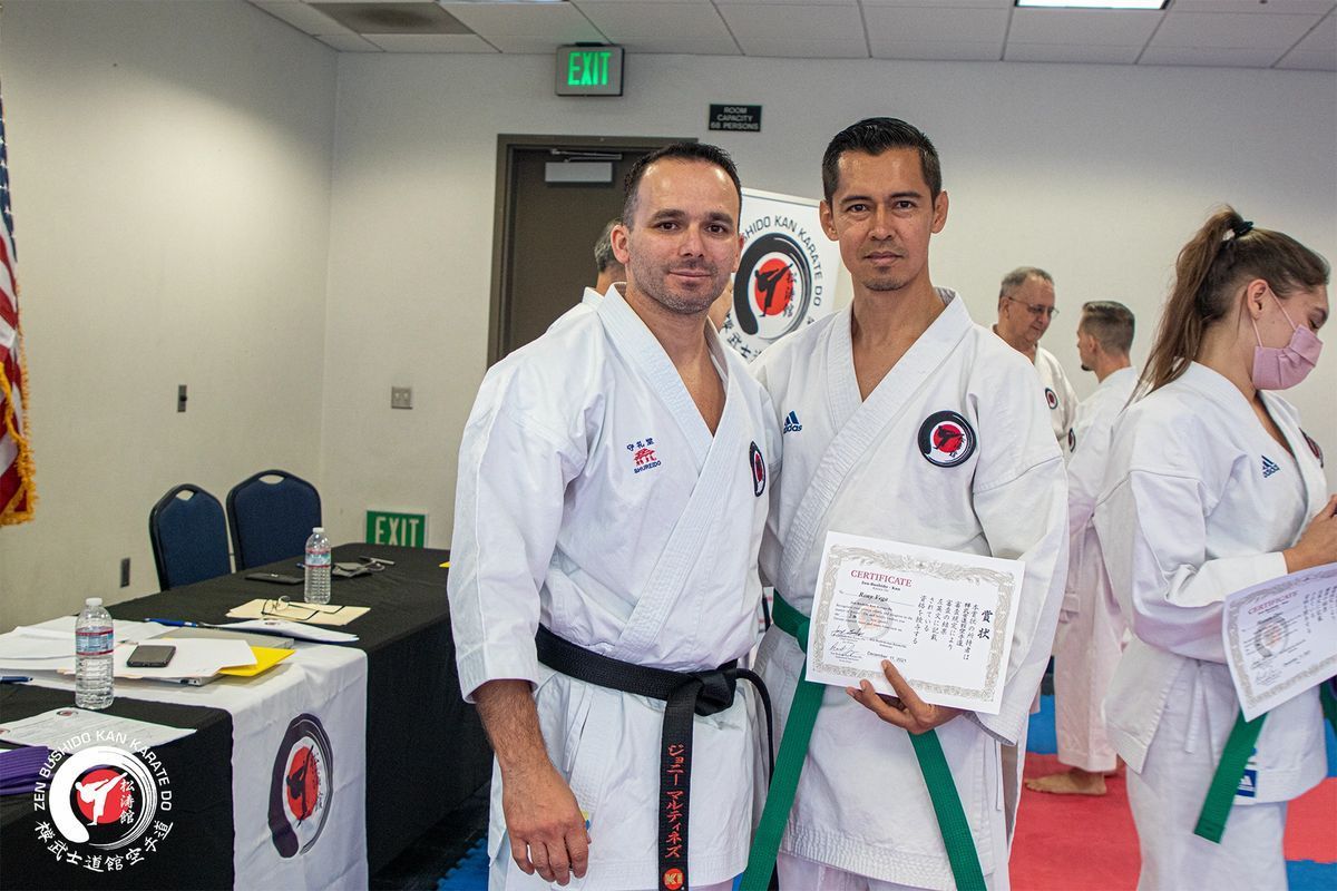 Two men in karate uniforms are posing for a picture in a room.