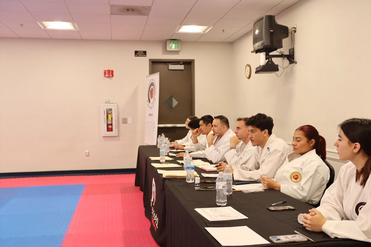 A group of people are sitting at tables in a room.