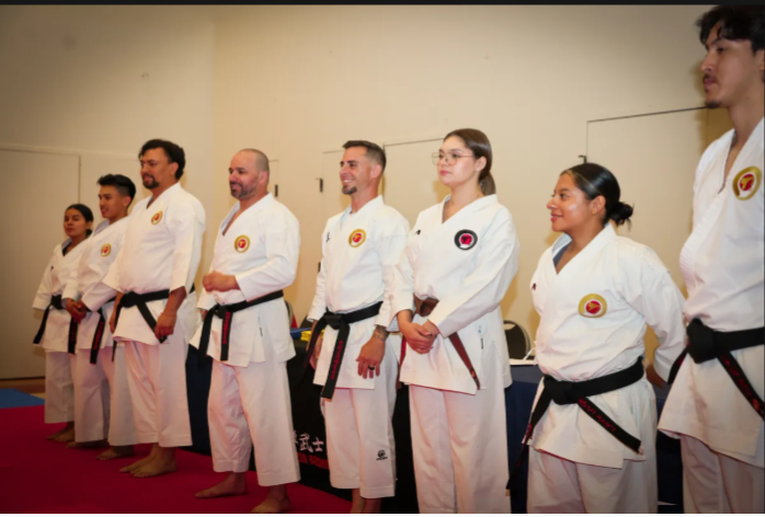 A group of people in karate uniforms are standing in a line