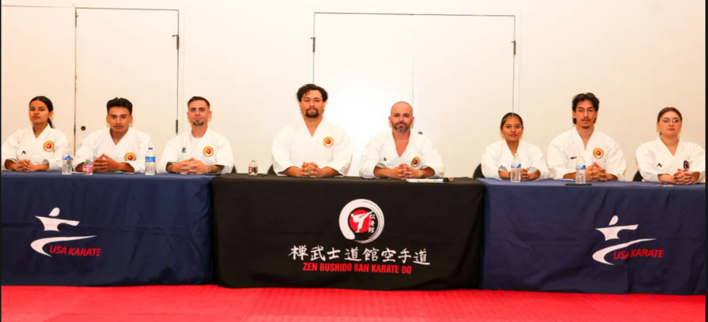A group of people are sitting at a table with chinese writing on it