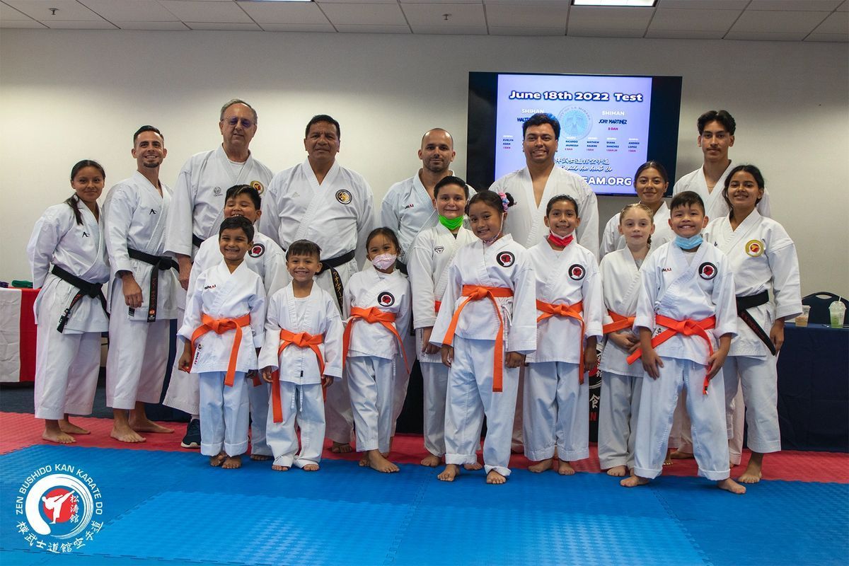 A group of people in karate uniforms are posing for a picture.