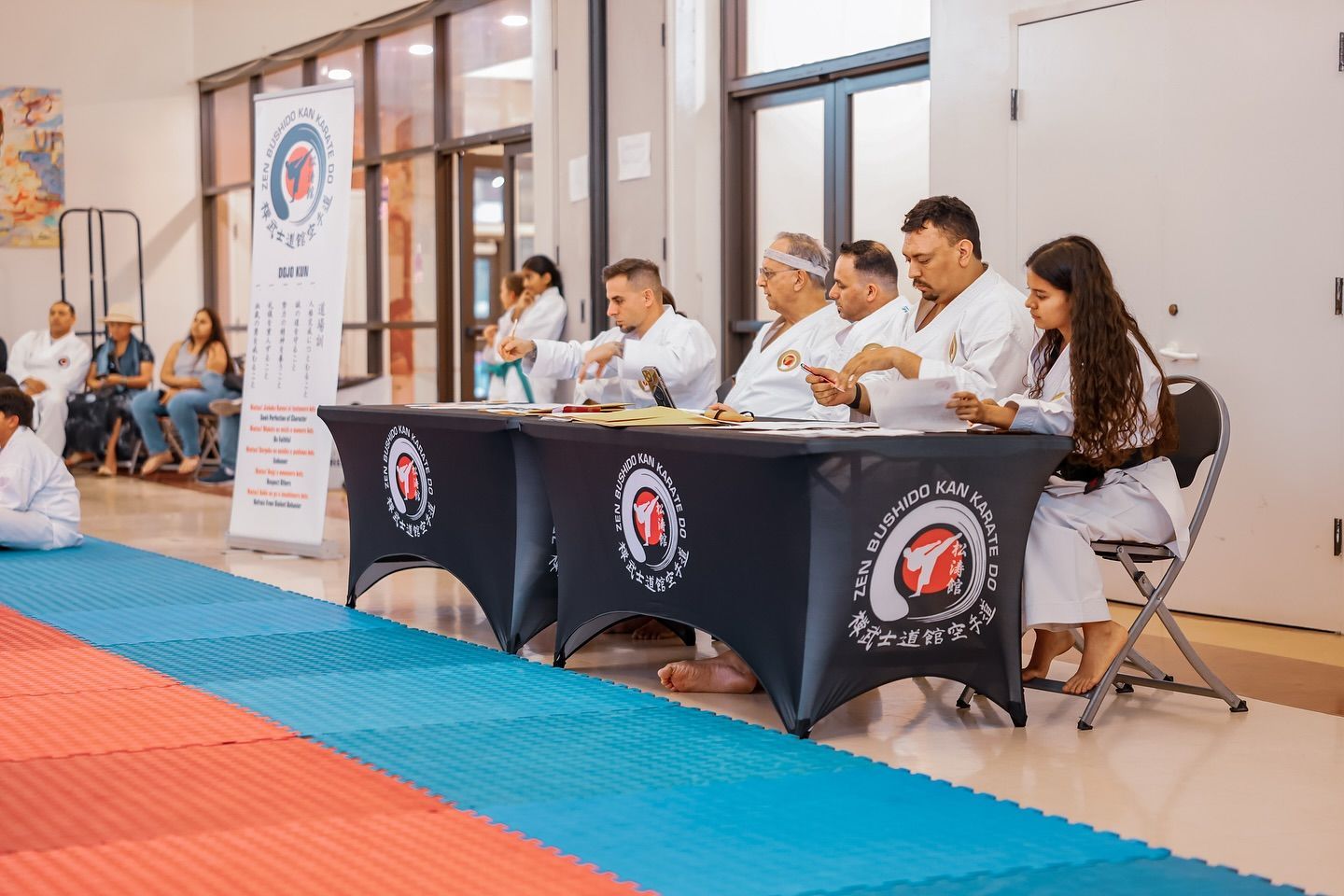 A group of people are sitting at tables in a room.