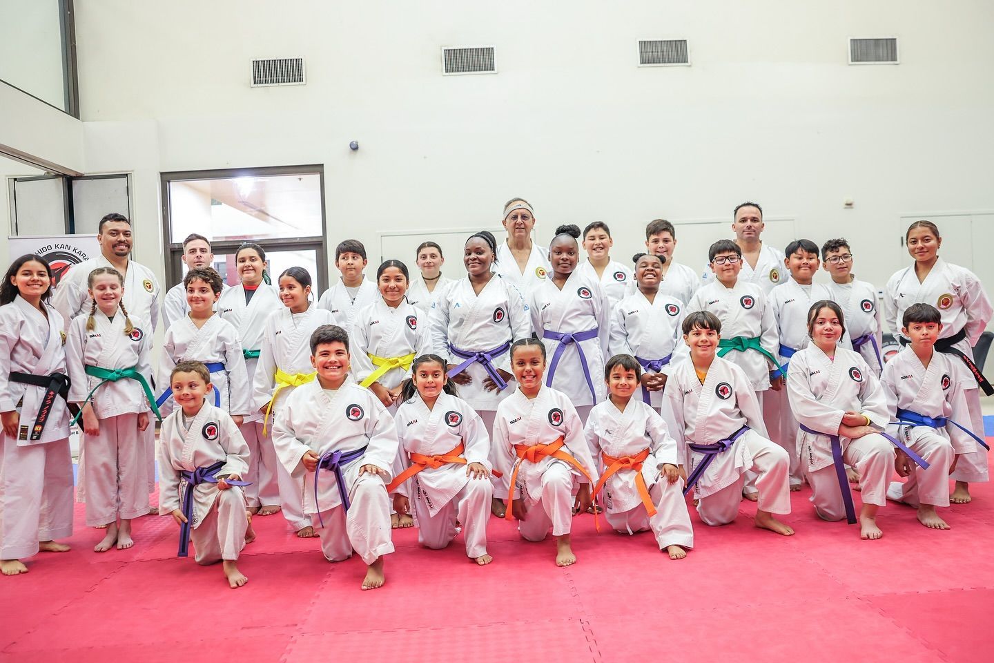 A group of people in karate uniforms are posing for a picture.