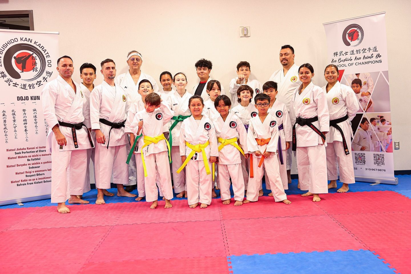 A group of people in karate uniforms are posing for a picture.