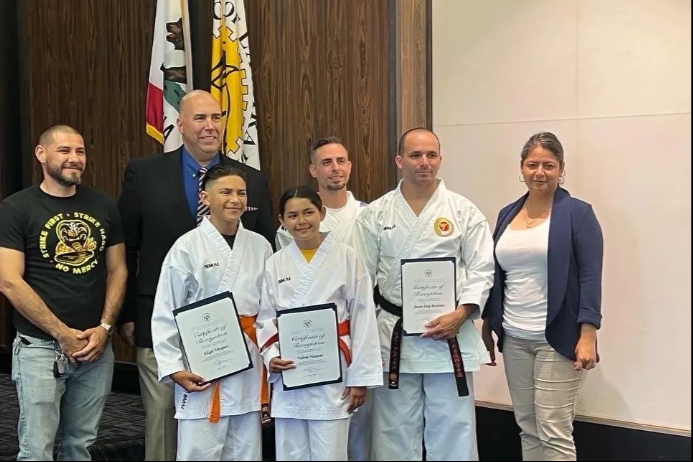 A group of people standing next to each other holding certificates.
