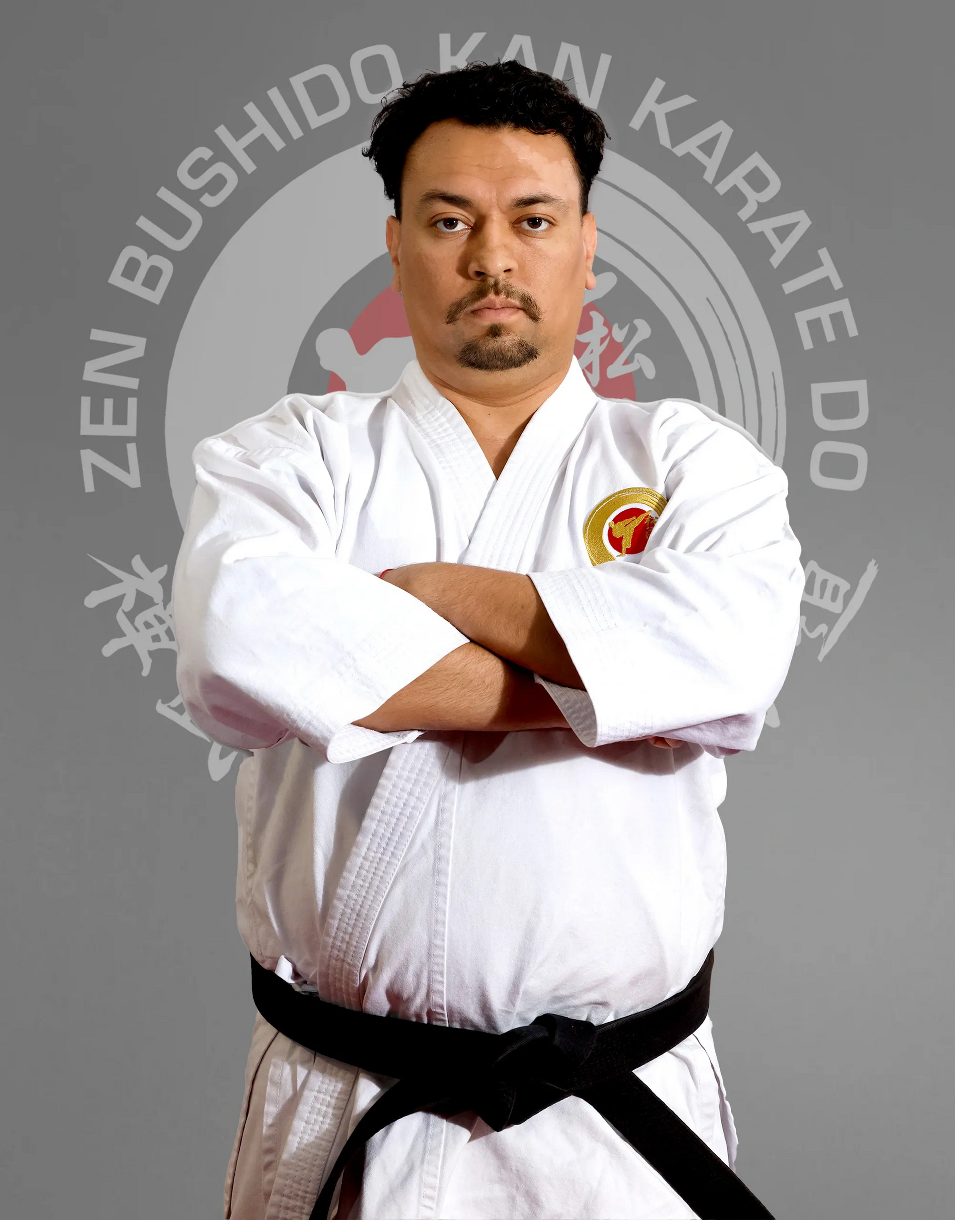 A man in a karate uniform with his arms crossed