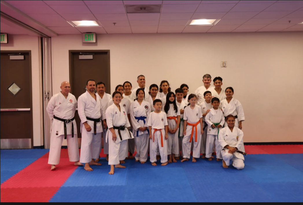 A group of people in karate uniforms pose for a picture