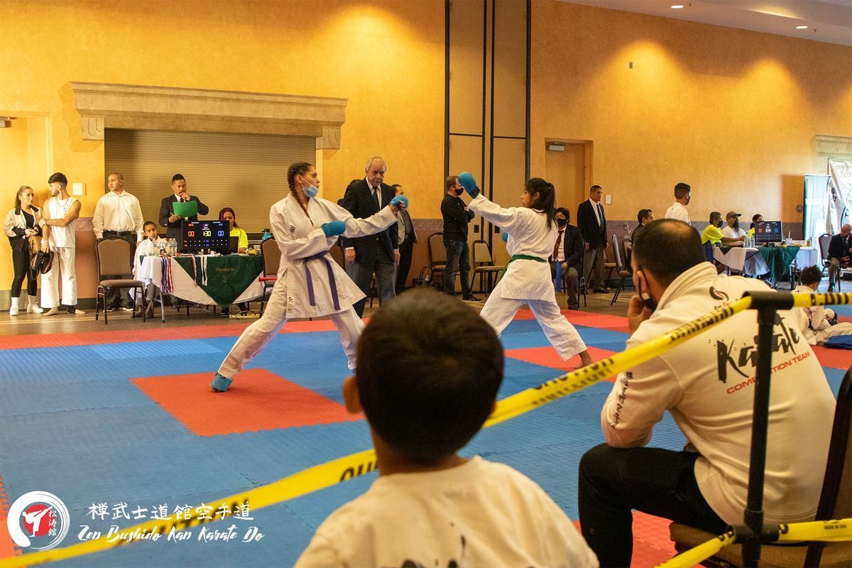 A man in a white shirt with the word karate on it