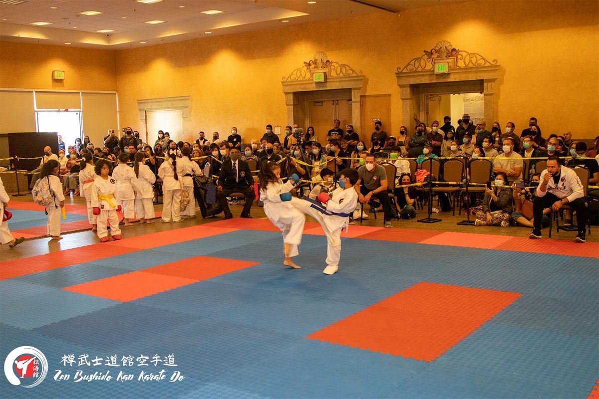 A group of kids are practicing martial arts in a gym
