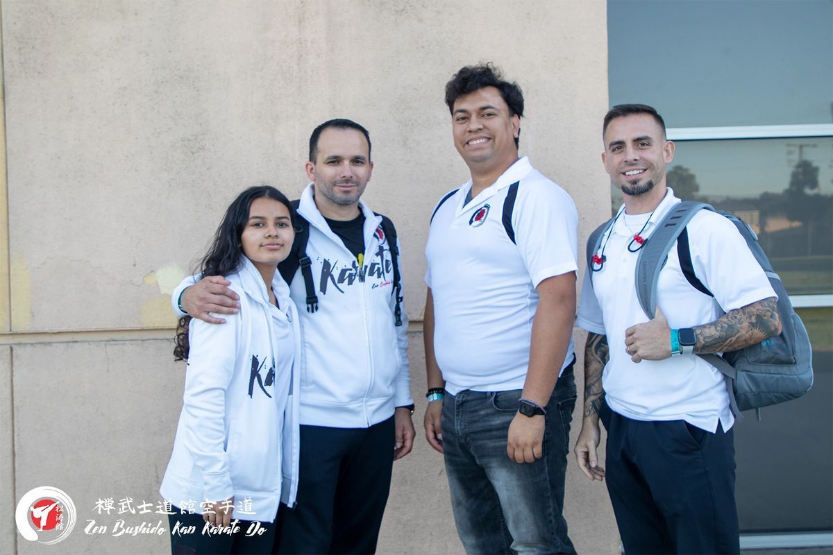 A group of people are posing for a picture in front of a building.