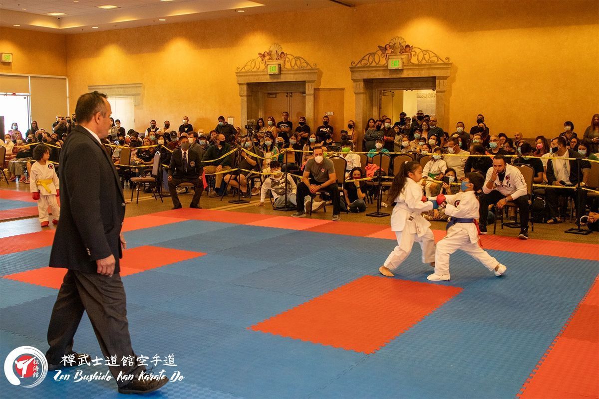 A man in a suit is walking across a karate mat