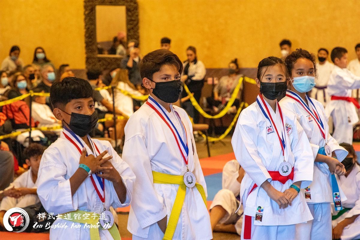 A group of children wearing masks and medals are standing in a line.