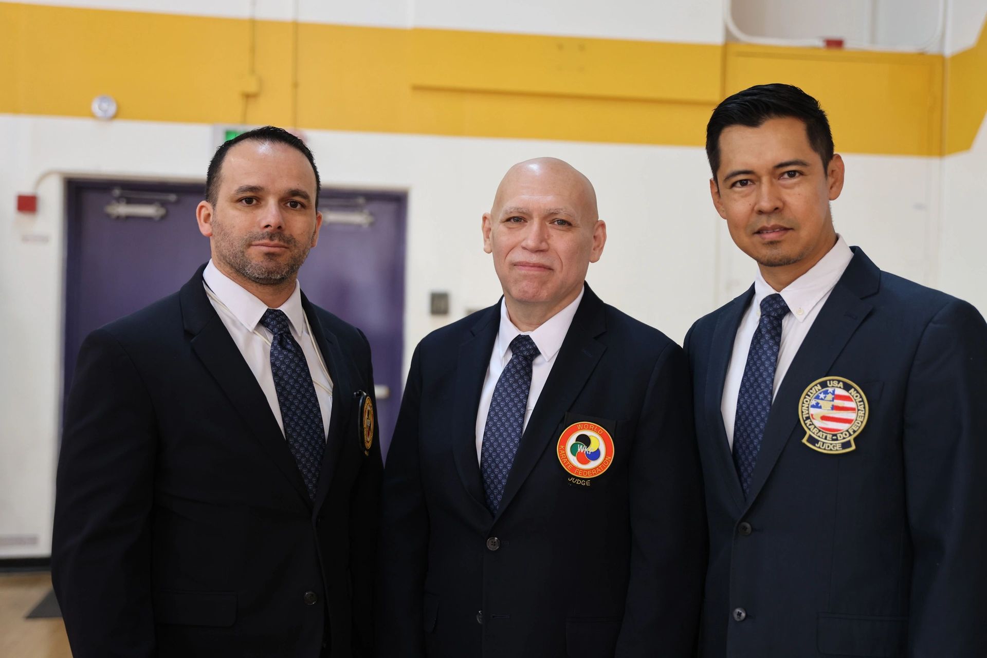 Three men in suits and ties are posing for a picture.
