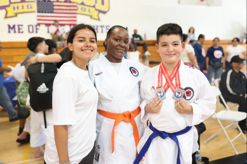 A group of young people are posing for a picture while holding medals.
