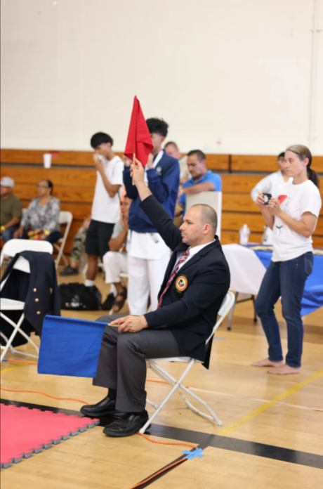 A man sitting in a chair holding a red flag